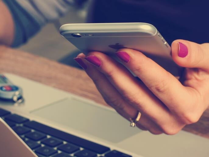 A hand holding a smartphone