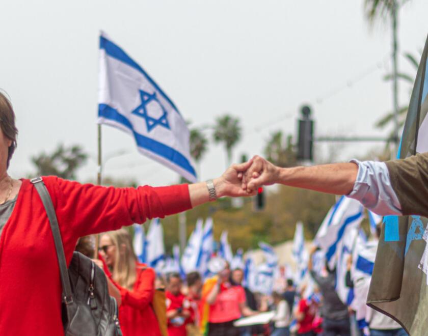 Israeli couple holding hands while protesting